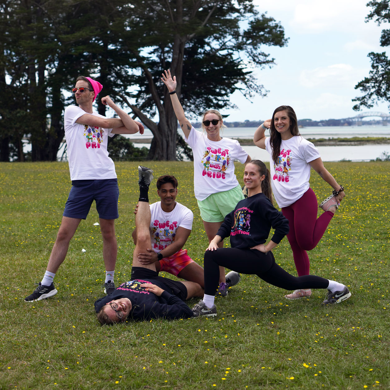 Photo of a team of workmates stretching in Auckland's Coyle Park wearing SWP merch