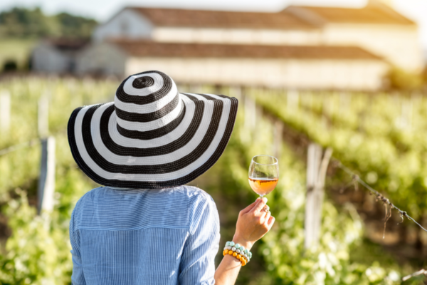 Woman holding wine glass in a vineyard
