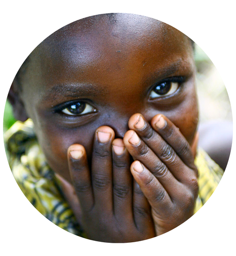 Girl smiling with hands over mouth